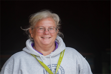 Female volunteer smiling at camera