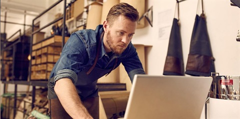 Person in their business looking at a laptop.JPG