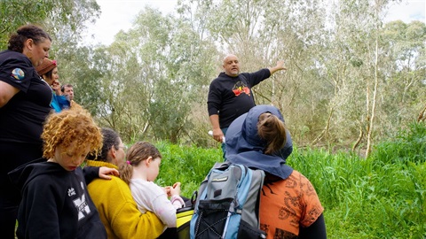 Image of Uncle Bill talking to a group 