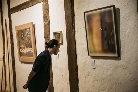 Man looking at art in Monsalvat