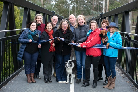 This is a photograph of the ribbon being cut for the official opening of the Diamond Creek Trail extension.