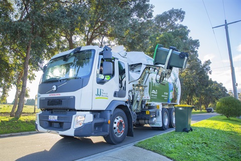 Photo of a Nillumbik rubbish collection truck, picking up a wheelie bin