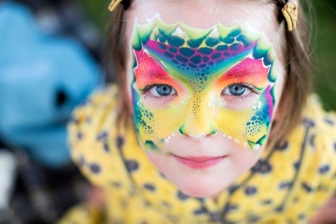 Little girl's face decorated with face paint